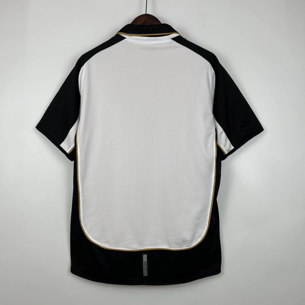 Camisa Dupla Face Retrô Manchester United 2001/02 100 Anos Masculina Branca e Preta ou Dourada